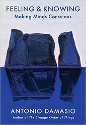 Damasio - Feeling and Knowing, Making Minds Conscious cover - title in blue on white background, large bule-gray stones reflected in bottom half in blue field of color